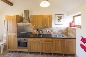 Whitley Coach House kitchen, with an electric ceramic glass hob, oven, microwave/oven, fridge/freezer, 1 1/2 sink and large Kenwood food mixer.