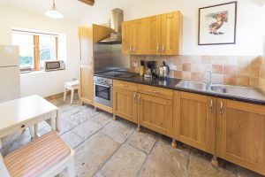 Whitley Coach House kitchen, with an electric ceramic glass hob, oven, microwave/oven, fridge/freezer, 1 1/2 sink and large Kenwood food mixer.