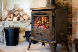 Roaring fireplace in the sitting room at The malthouse in Norton St Philip near the city of Bath